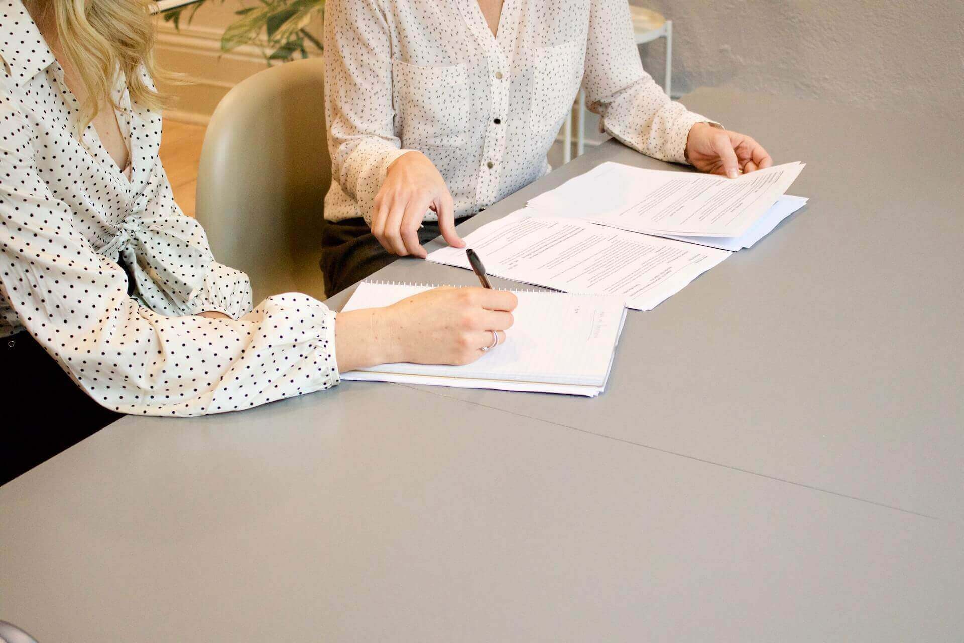 Two women writing SOP document