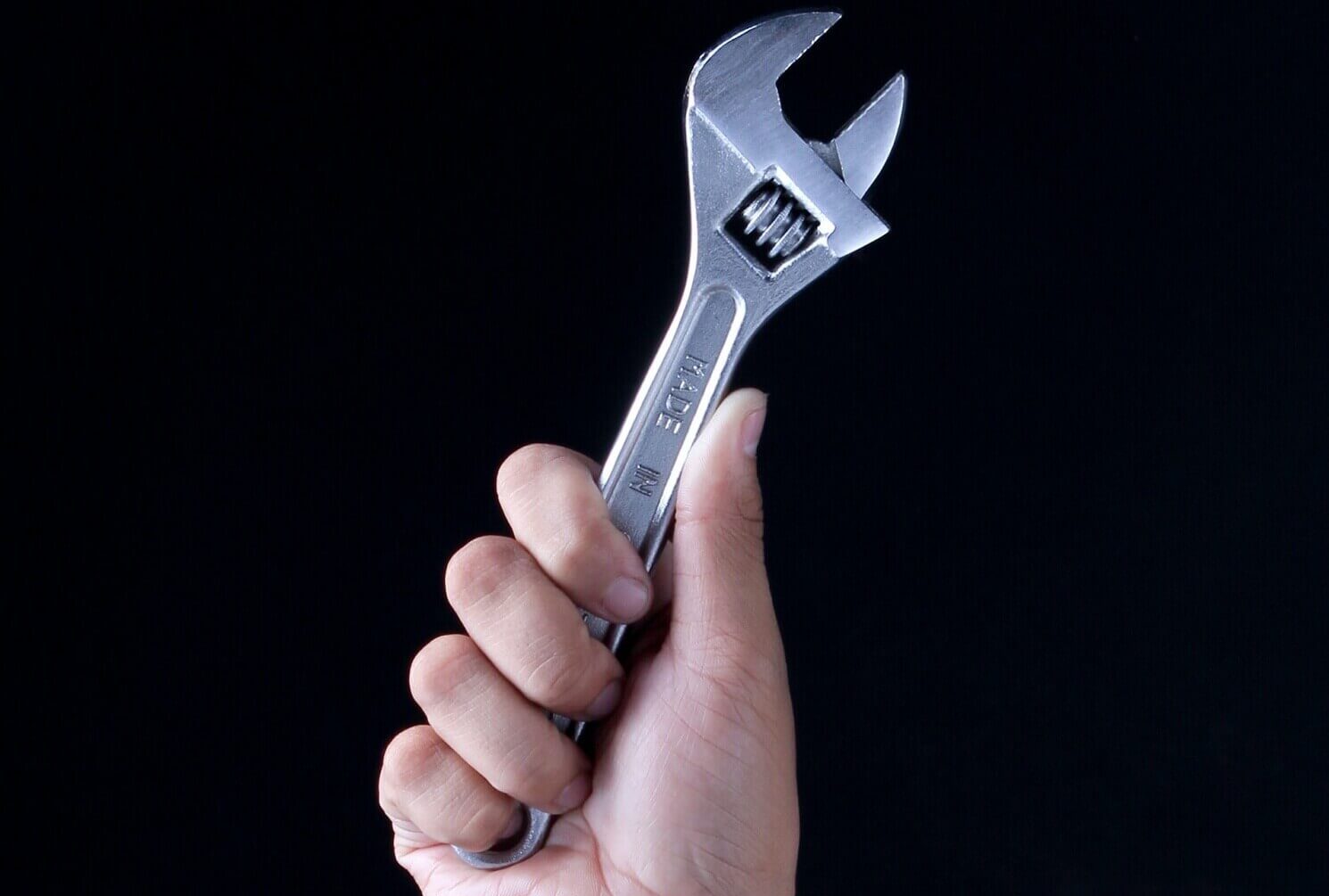 hand holding a wrench