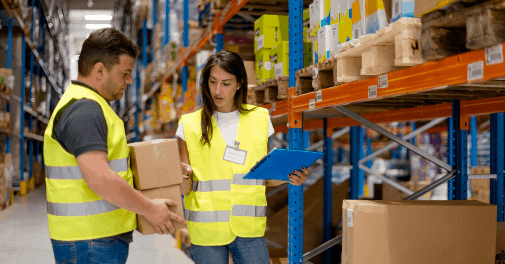 Man and woman in warehouse. 