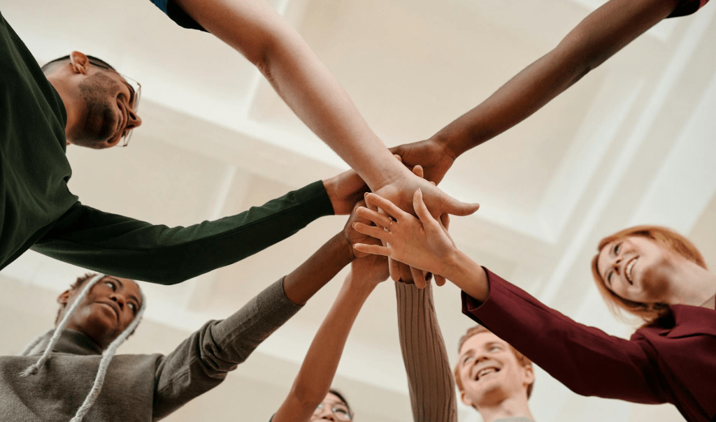 Group of people spreading hands