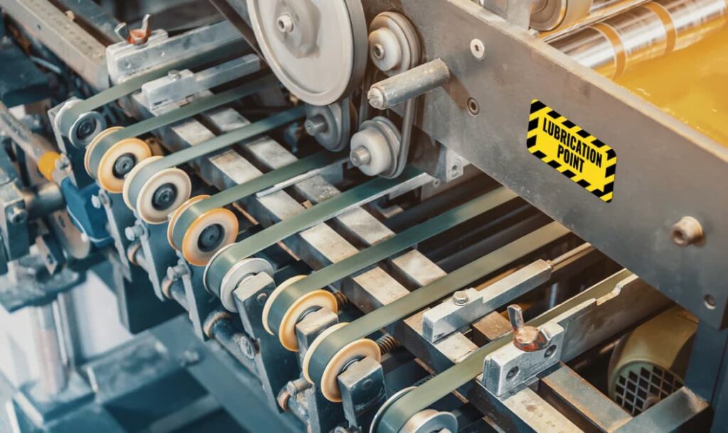 Industrial conveyor system with marked lubrication point for routine maintenance